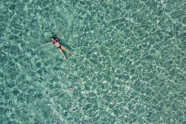 Jeune femme dans les eaux baignant l'île Chrysi près de la Crète. - Sputnik Afrique