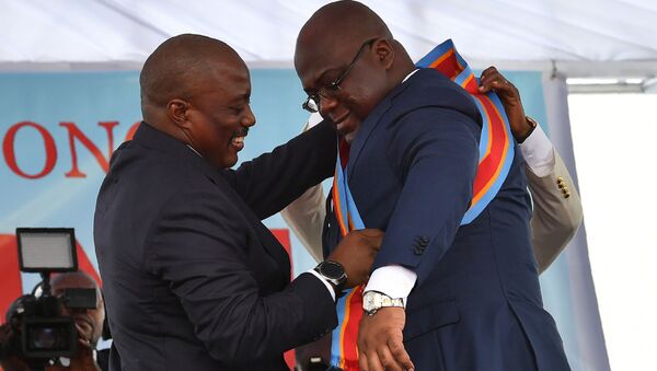 Le Président sortant de la RDC Joseh Kabila aide le nouveau Président Felix Tshisekedi à ceindre l'écharpe. - Sputnik Afrique
