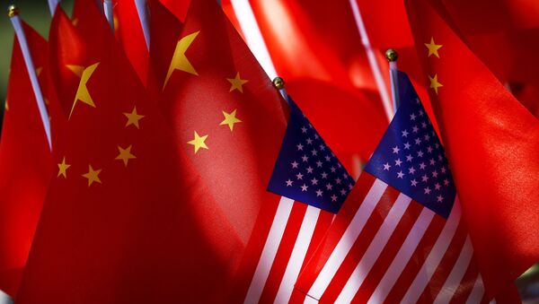  In this Sept. 16, 2018, file photo, American flags are displayed together with Chinese flags on top of a trishaw in Beijing. China’s Commerce Ministry said Thursday, Nov. 15, 2018, that high-level trade talks between Washington and Beijing have resumed - Sputnik Afrique