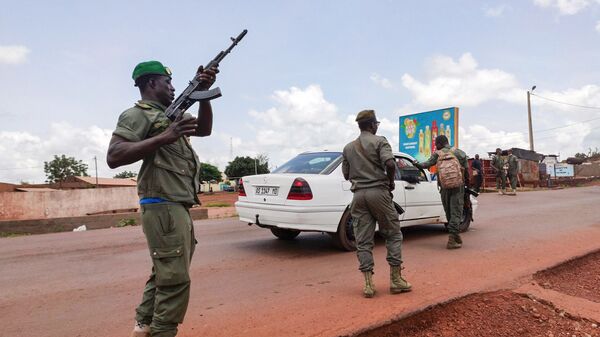 Des soldats maliens contrôlent un véhicule dans la ville de garnison de Kati, au Mali, mardi 18 août 2020. Les soldats maliens ont pris les armes et ont commencé à détenir des officiers supérieurs de l'armée dans une mutinerie apparente, suscitant des craintes d'un coup d'État potentiel après plusieurs mois de manifestations antigouvernementales appelant à la démission du président.  - Sputnik Afrique