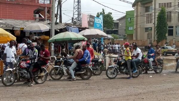 Des chauffeurs de mototaxi et des passagers non masqués dans un carrefour de Douala. - Sputnik Afrique