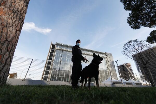 Un policier avec un chien devant le centre de congrès La Nuvola. - Sputnik Afrique