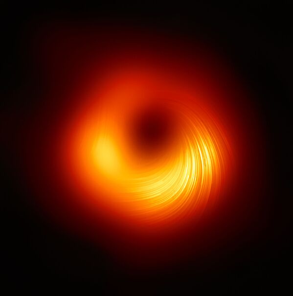 Un trou noir dans la galaxie M87. L’image, qui montre des tourbillons de flux magnétiques, a été publiée le 24 mars par les membres du projet scientifique international Event Horizon Telescope. - Sputnik Afrique