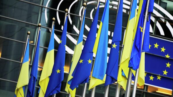 Ukraine and European Union flags hang together on the exterior of the building prior to an extraordinary plenary session on Ukraine at the European Parliament in Brussels, Tuesday, March 1, 2022 - Sputnik Africa
