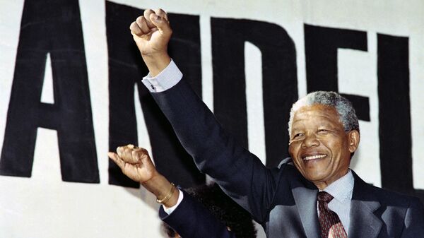 Anti-apartheid leader and African National Congress (ANC) member Nelson Mandela raises clenched fist, arriving at the human rainbow music concert organised by local artists to celebrate ANC leader's release from 27 years of imprisonment last 11 February, at Ellis Park stadium in Johannesburg, on March 17, 1990. - Sputnik Africa