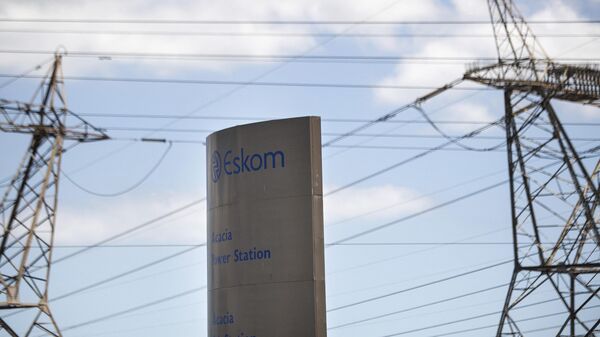 A sign for Eskom, the South African electricity authority, stands next to electricity pylons near Cape Town on January 22, 2023.  - Sputnik Africa