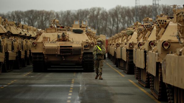 A U.S. soldier walks past parked armoured vehicles and tanks of the 1st Armored Brigade Combat Team and 1st Calvary Division, based out of Fort Hood, Texas, as they are unloaded at the port of Antwerp, Belgium, Monday, Nov. 16, 2020. The U.S. military vehicles are on their way to Eastern Europe to take part in the Atlantic Resolve military exercises, in which American troops train together with NATO partners to help ensure stability in Europe. - Sputnik Africa