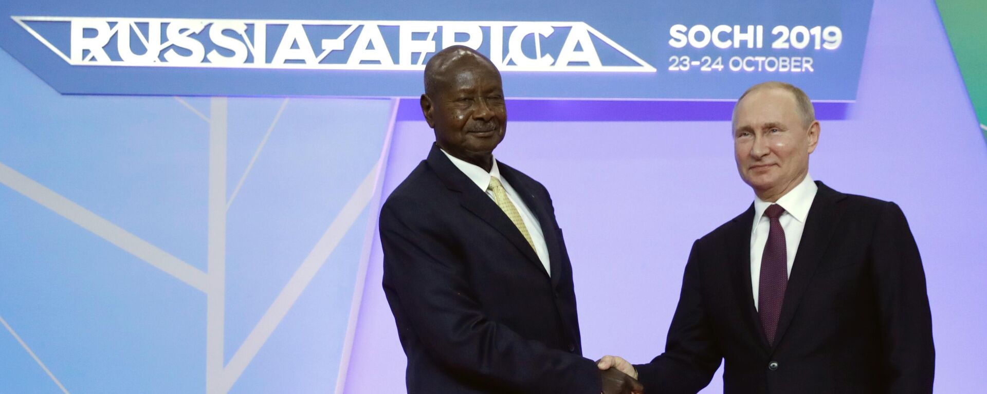 Russian President Vladimir Putin, left, shakes hands with Ugandan President Yoweri Museveni during their meeting on the sideline of Russia-Africa summit in the Black Sea resort of Sochi, Russia, Wednesday, Oct. 23, 2019.  - Sputnik Africa, 1920, 20.05.2023