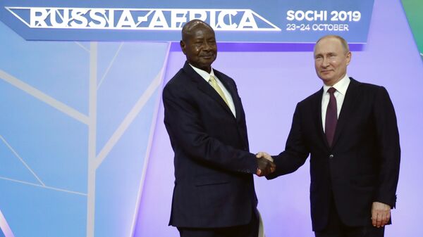 Russian President Vladimir Putin, left, shakes hands with Ugandan President Yoweri Museveni during their meeting on the sideline of Russia-Africa summit in the Black Sea resort of Sochi, Russia, Wednesday, Oct. 23, 2019.  - Sputnik Africa