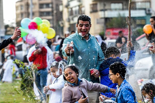 Muslim revelers spray foam at each other after prayers on the first day of Eid al-Fitr to celebrate the end of the holy fasting month of Ramadan outside Egypt&#x27;s Al-Seddiq Mosque in Cairo on April 21, 2023.  - Sputnik Africa