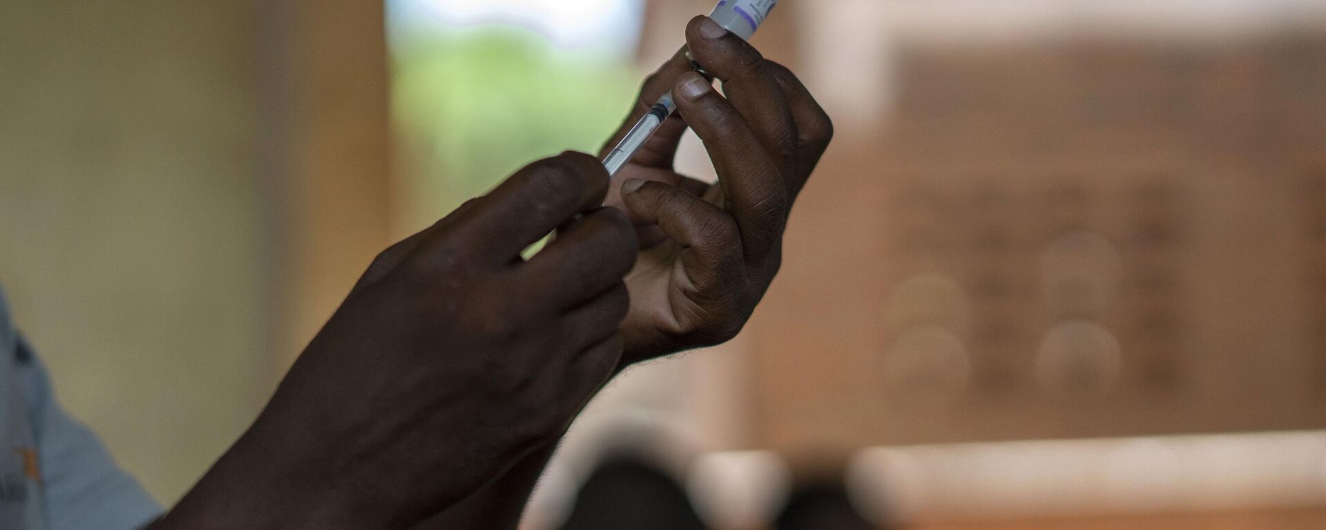 In this photo taken Wednesday, Dec. 11, 2019, health officials prepare to vaccine residents of the Malawi village of Tomali, where young children become test subjects for the world's first vaccine against malaria. - Sputnik Africa, 1920, 22.04.2023