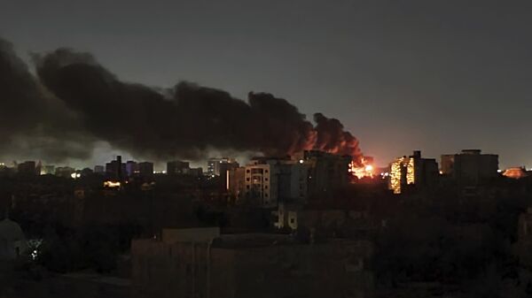 Smoke rises over the horizon as a fire burns after a strike in Khartoum, Sudan, Sunday, April 16, 2023. - Sputnik Africa