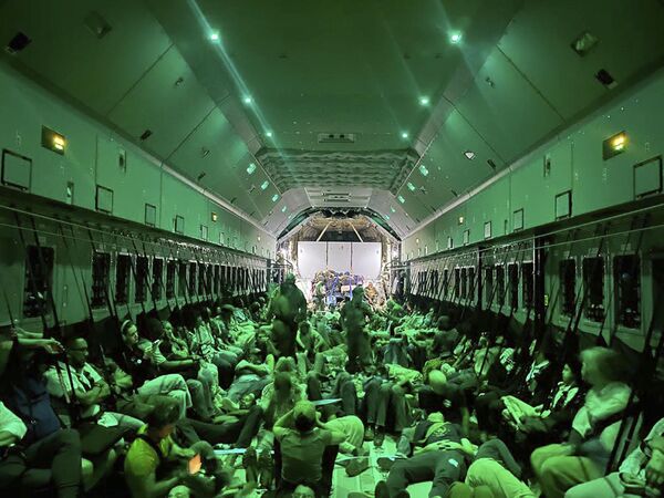 In this photo from the Spanish Defense Ministry, citizens of different nationalities, fleeing Sudan, sit inside a Spanish Air Force aircraft on its way to Madrid on Monday, 24 April 2023. - Sputnik Africa