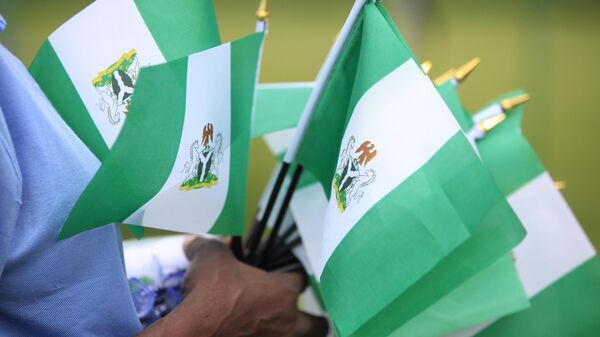 An unidentified woman sells Nigerian national flags, during an event to mark Nigeria independence day, in Lagos, Nigeria. Tuesday, Oct. 1, 2013 - Sputnik Africa