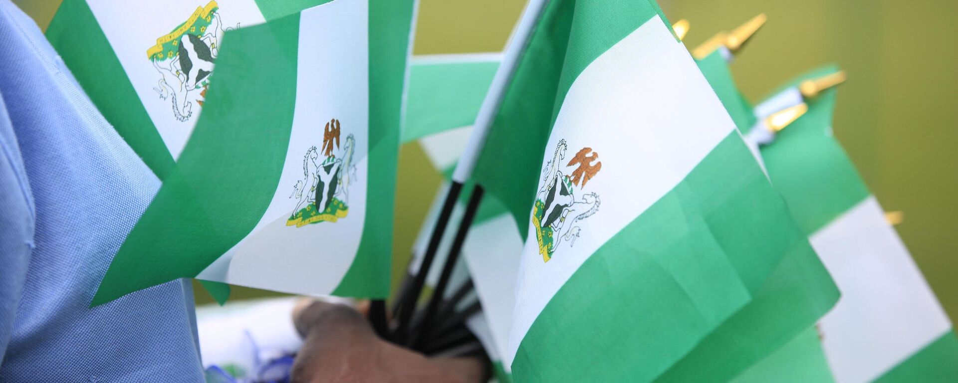 An unidentified woman sells Nigerian national flags, during an event to mark Nigeria independence day, in Lagos, Nigeria. Tuesday, Oct. 1, 2013 - Sputnik Africa, 1920, 16.10.2023