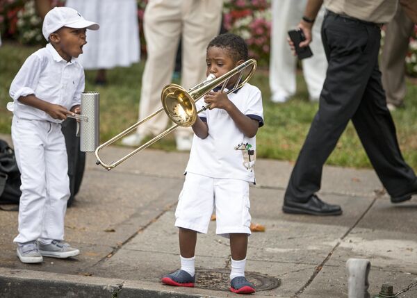 Youngsters raised in the traditional music of the Southern &quot;shout bands&quot; mirror the music of their elders as congregants of The United House of Prayer for All People gather for a public street baptism in Washington, D.C., on Memorial Day weekend, Sunday, August 30, 2015.  - Sputnik Africa
