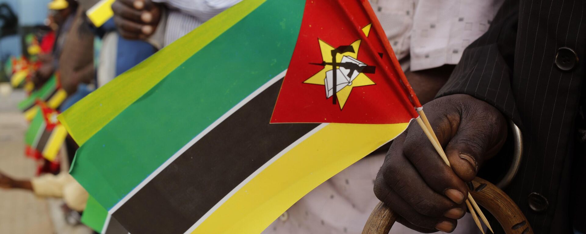 An old man holds Mozambican flag as people wait for the arrival of India's Prime Minister Narendra Modi at a technical school in Maluana, Mozambique, Thursday, July 7, 2016 - Sputnik Africa, 1920, 22.06.2023
