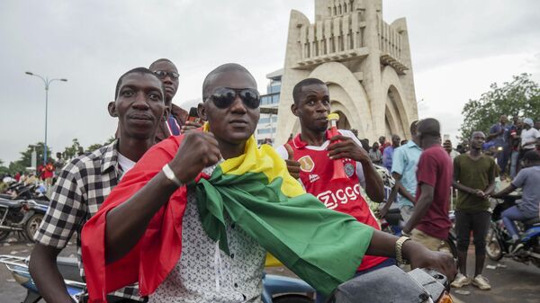 A man wears a national flag as he celebrates with others in the streets in the capital Bamako, Mali Tuesday, Aug. 18, 2020 - Sputnik Africa