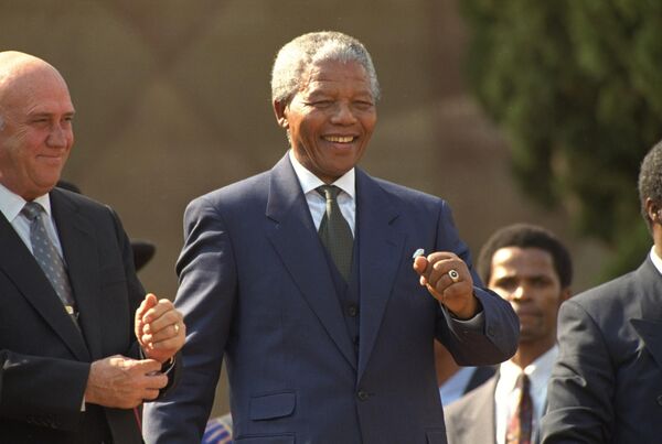 President Nelson Mandela dances at a celebration concert following his inauguration at the Union Buildings in Pretoria, South Africa, Tuesday, May 10, 1994, along with former President F.W. de Klerk.  &quot;Never, never, and never again shall it be that this beautiful land will again experience the oppression of one by another and suffer the indignity of being the skunk of the world,&quot;  Mandela vowed.  - Sputnik Africa