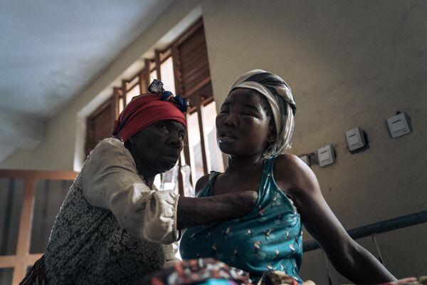 An elderly woman tends to an injured woman, hospitalized after heavy flooding in the eastern Democratic Republic of the Congo, on May 6, 2023. Heavy rainfall in the Kalehe region of South Kivu province on Thursday caused rivers to overflow, triggering landslides that engulfed the villages of Bushushu and Nyamukubi.  - Sputnik Africa