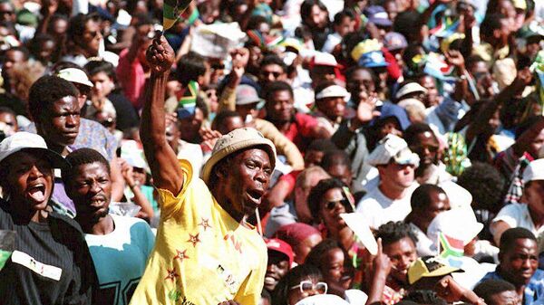 A supporter waves an ANC flag during Nelson Mandela's inauguration 10 May 1994 at the Union Buildings in Pretoria as South Africa's first democratically elected president - Sputnik Africa