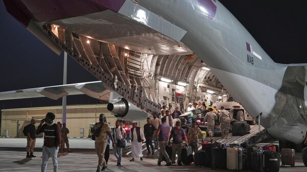 Evacuees flown out of Sudan disembark a Qatari C-17 Globemaster at Al Udeid Air Base, Qatar, Saturday, May 6, 2023.  - Sputnik Africa