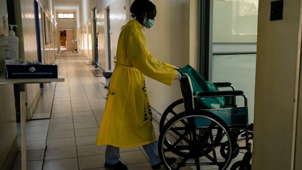 A nurse pushes a wheelchair along a corridor in a medical ward at a local hospital in Harare on April 26, 2022. - Sputnik Africa