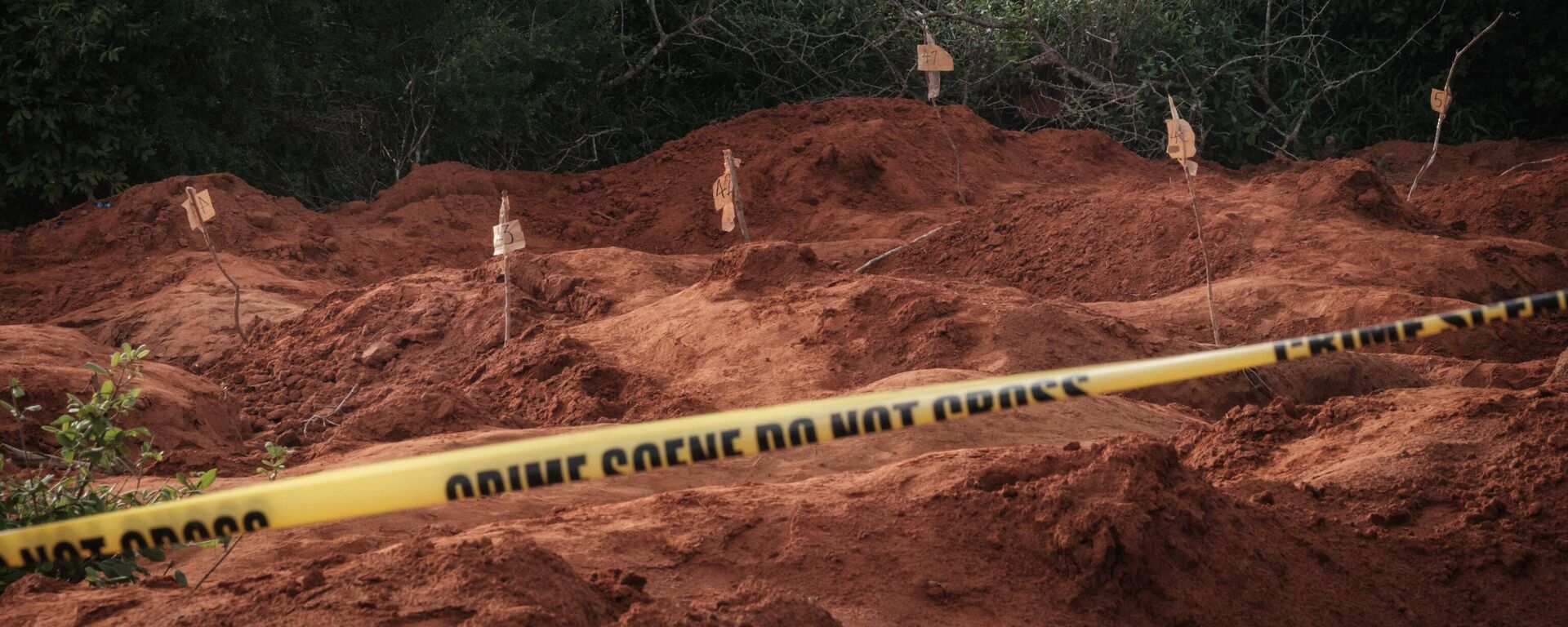 In this file photo taken on April 25, 2023 Digged holes are seen after exhuming bodies at the mass-grave site in Shakahola, outside the coastal town of Malindi - Sputnik Africa, 1920, 14.05.2023