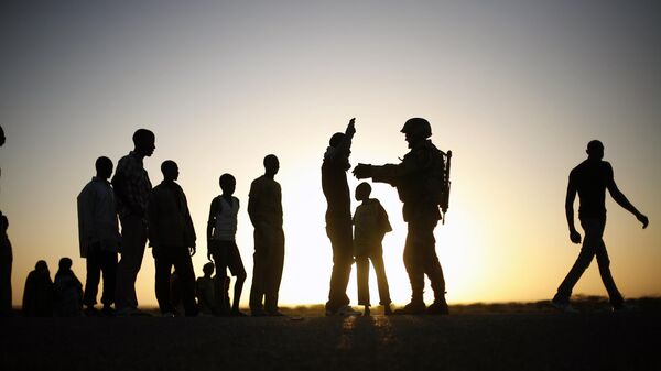 A French soldier checks passengers of a transport truck arriving in Gao, northern Mali, Feb. 14, 2013. - Sputnik Africa