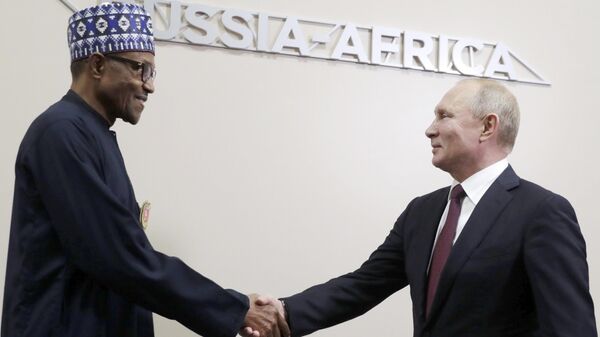 Russian President Vladimir Putin, right, and Nigerian President Muhammadu Buhari shake hands during their meeting on the sideline of Russia-Africa summit - Sputnik Africa