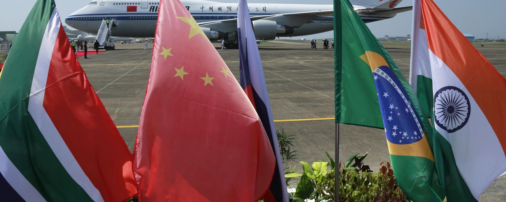 Flags of the five countries that make up BRICS fly in front of an Air China aircraft in which Chinese President Xi Jinping arrived to attend the BRICS summit in Goa, India, Saturday, Oct. 15 2016. Leaders of Brazil, Russia, India, China and South Africa are meeting for their eighth BRICS summit, beginning with a dinner on Saturday and ending on Sunday. - Sputnik Africa, 1920, 30.05.2023