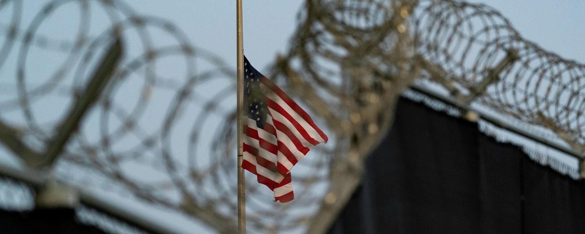 In this Aug. 29, 2021, file photo reviewed by U.S. military officials, a flag flies at half-staff in honor of the U.S. service members and other victims killed in the terrorist attack in Kabul, Afghanistan, as seen from Camp Justice in Guantanamo Bay Naval Base, Cuba. - Sputnik Africa, 1920, 19.05.2023