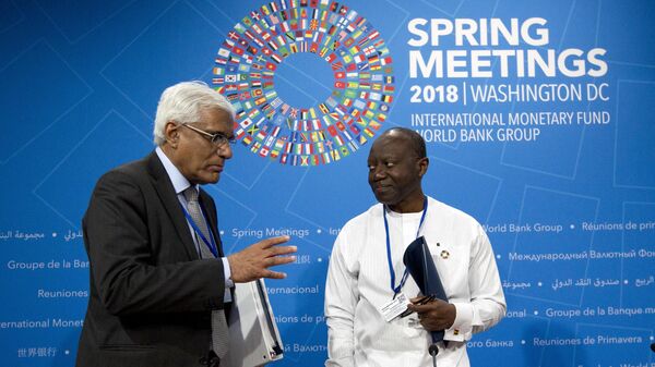 Governor of the Central Bank of Sri Lanka, Dr. Indrajit Coomaraswamy left, speaks with Ghana's Finance Minister, Ken Ofori-Atta after a G-24 news conference at the World Bank/IMF Spring Meetings, in Washington, Thursday, April 19, 2018. - Sputnik Africa