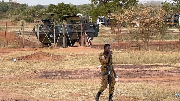 A Burkinabe soldier walks past a French Armoured Personnel Carrier part of a French military convoy heading to Niger, stopped by protesters in Kaya, Burkina Faso, Saturday Nov. 20, 2021 - Sputnik Afrique