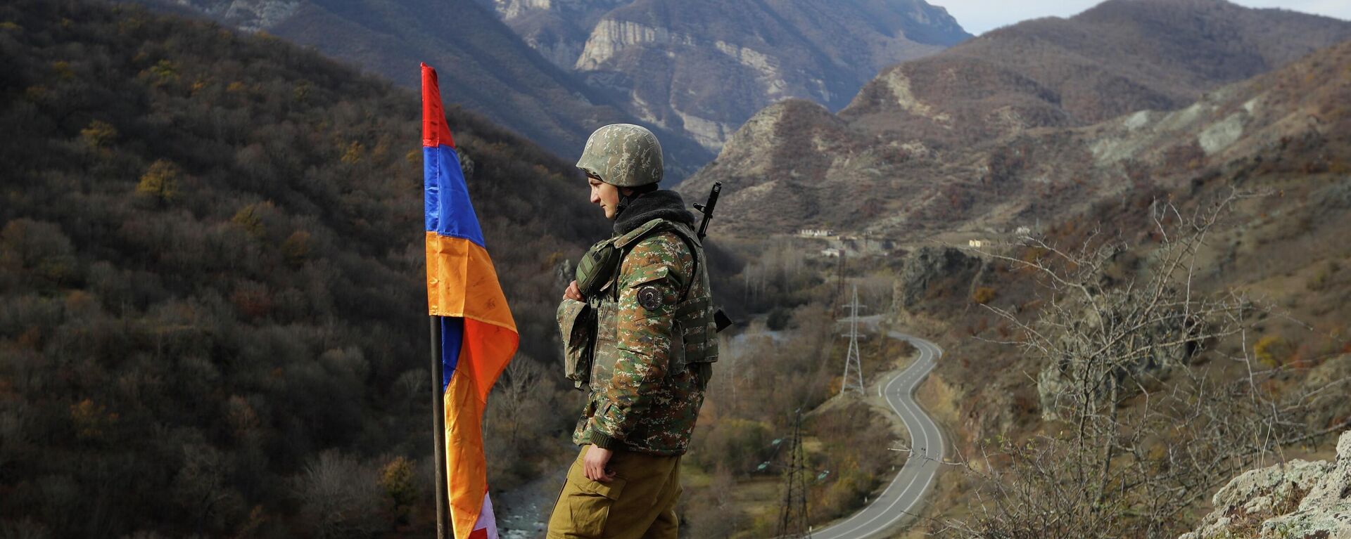 FILE - In this Wednesday, Nov. 25, 2020 file photo, An ethnic Armenian soldier stands guard next to Nagorno-Karabakh's flag atop of the hill near Charektar , Nov. 25, 2020 - Sputnik Africa, 1920, 22.05.2023