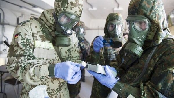 German Bundeswehr soldiers from the CBRN (Chemical Biological Radiological Nuclear) Defence Battalion 750 use a chemical agent detector to identify a simulated chemical weapon agent. File photo. - Sputnik Africa