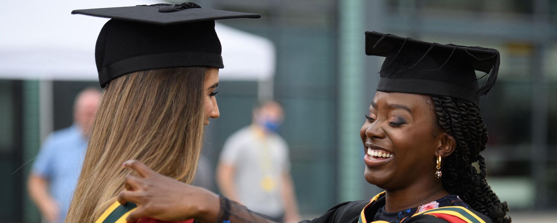 Students smile after after taking part in a Covid-safe, in-person graduation ceremony at the University of Bolton, northwest England on July 9, 2021.  - Sputnik Africa, 1920, 24.05.2023