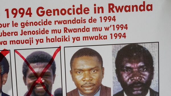 A picture taken on May 19, 2020, shows the faces of Protais Mpiranya, one of the key suspects in the 1994 Rwandan genocide, on a wanted poster on the wall at the Genocide Fugitive Tracking Unit office in Kigali, Rwanda. - Sputnik Africa