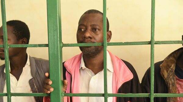Self-proclaimed pastor Paul Nthenge Mackenzie (C) who set up the Good News International Church in 2003 and is accused of inciting cult followers to starve to death to meet Jesus, appears at the Shanzu law courts in Mombasa on May 5, 2023. - Sputnik Africa