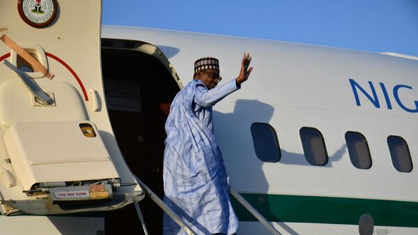 Nigerian President Muhammadu Buhari waves as he gets into the plane after addressing troops at the airforce base in Maiduguri on December 23, 2021.  - Sputnik Africa