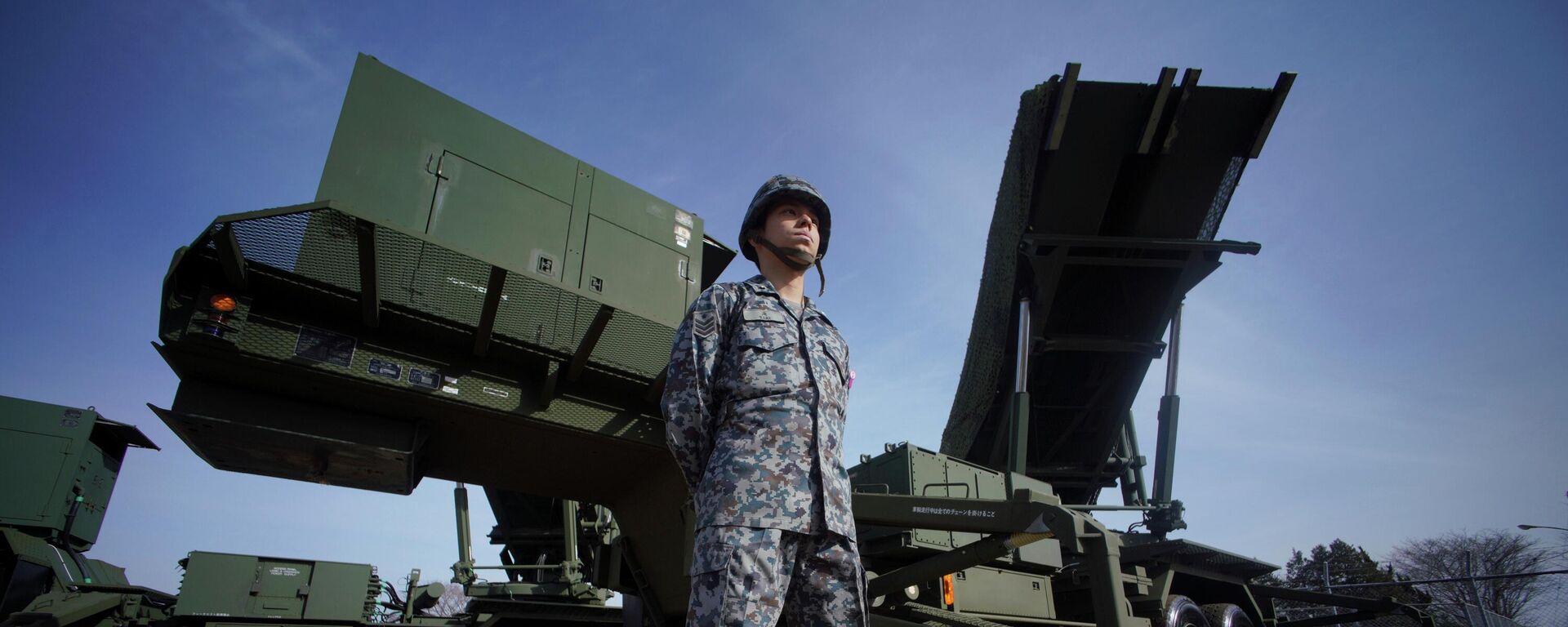 In this Jan. 18, 2018, file photo, a member of the Japan Ground Self-Defense Force stands guard next to a surface-to-air Patriot Advanced Capability-3 (PAC-3) missile interceptor launcher vehicle at Narashino Exercise Area in Funabashi, east of Tokyo.  - Sputnik Africa, 1920, 29.05.2023