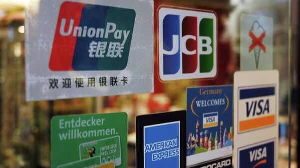 UnionPay, Visa and other payment card logos on the glass of a shop in Germany. File photo. - Sputnik Africa