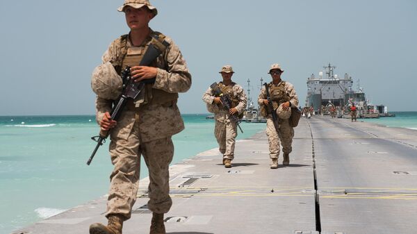 U.S. Marines walk down a removable Trident Pier leading to an American ship docked near an Emirati military base home to a Military Operations and Urban Terrain facility in al-Hamra, United Arab Emirates, Monday, March 23, 2020. U.S. Marines and Emirati forces held the biennial exercise, called Native Fury, that saw forces seize a sprawling model Mideast city. The drill on Monday was conducted amid tensions with Iran and despite the global new coronavirus pandemic.  - Sputnik Africa