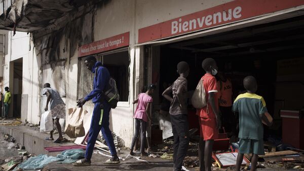 A man walks out a destroyed supermarket in Dakar, Senegal, Saturday, June 3, 2023 - Sputnik Africa
