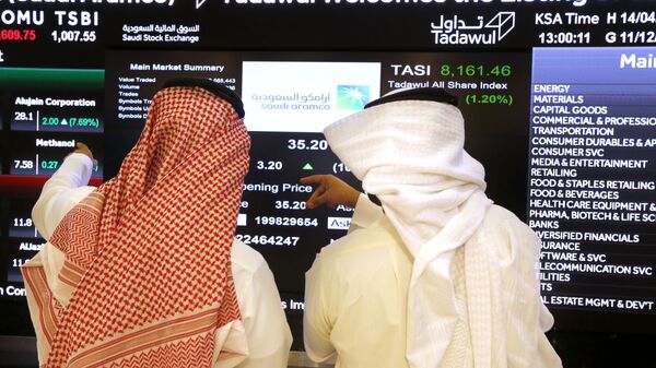 Saudi stock market officials watch the market screen displaying Saudi Arabia's state-owned oil company Aramco after the debut of Aramco's initial public offering (IPO) on the Riyadh's stock market in Riyadh, Saudi Arabia, Wednesday, Dec. 11, 2019 - Sputnik Africa