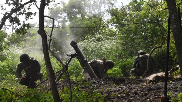 Russian servicemen of a mortar unit fire a 2B11 Sani (Sleigh) mortar towards Ukrainian positions, in the course of Russia's military operation in Ukraine, in Lugansk People's Republic, Russia - Sputnik Africa
