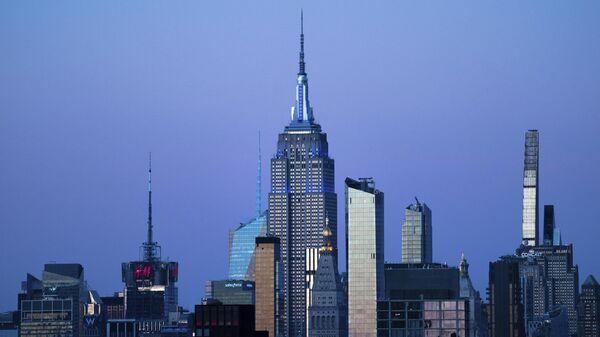 The Empire State Building glows blue during dusk, Monday, Nov. 14, 2022, in New York.  - Sputnik Africa