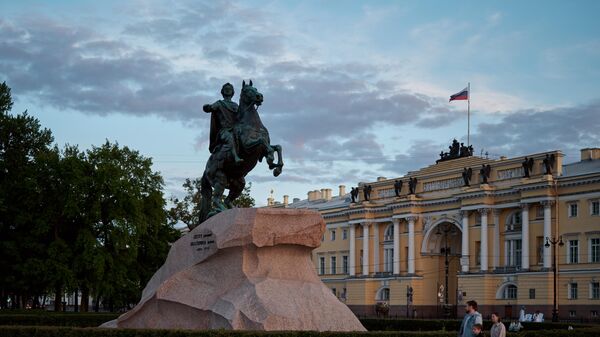 People walk past the Bronze Horseman monument to the first Russian Emperor Peter the Great on Senate Square during the White Nights in St. Petersburg. - Sputnik Africa