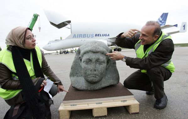 French archaeologist Franck Goddio (R) and Egyptian curator Snaa Fouad Zaki (L) from Cairo&#x27;s Museum, show the statue of Cesarion, upon its arrival aboard a Beluga plane from Cairo, at Roissy airport, near Paris, 16 November 2006. The black granite statue, shown in Paris museum, le Grand Palais  in the exhibition &quot;Tresors engloutis d&#x27;Egypte&quot; (Egyptian immersed treasures), from 09 December 2006 to 14 March 2007, was found at the port of Alexandria by Goddio. Ptolemee XV, better known as Cesarion, is the illegal son of Cleopatra, Queen of Egypt (from -51 to -30 before J.C) and was killed by Roman Emperor Octavius.  - Sputnik Africa