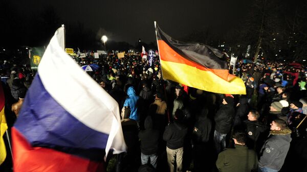 Demonstrators wave flags of Germany and Russia during a rally on January 5, 2015 in Dresden, Eastern Germany. - Sputnik Africa